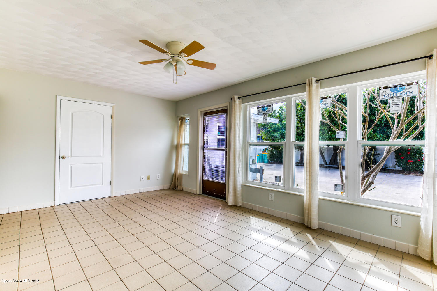 201 Ocean View Lane Melbourne, FL 32903 - Photo 7 of 21 a view of empty room with wooden floor and fan