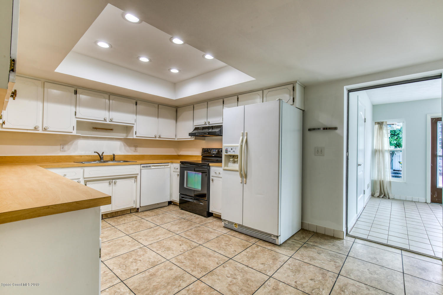 201 Ocean View Lane Melbourne, FL 32903 - Photo 8 of 21 a kitchen with a refrigerator a sink and a stove top oven