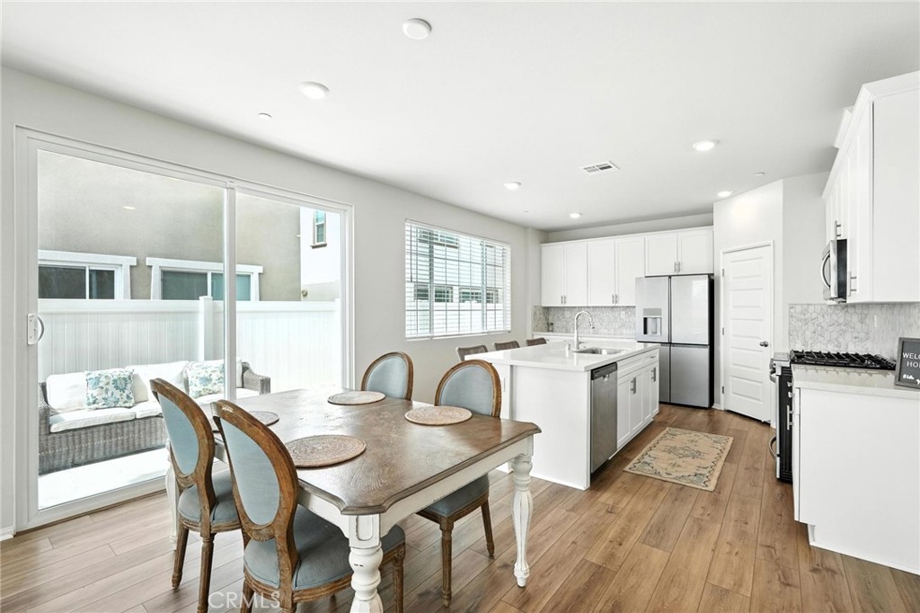28267 Ashtree Street Temecula, CA 92591 - Photo 12 of 41 a kitchen with sink table and chairs