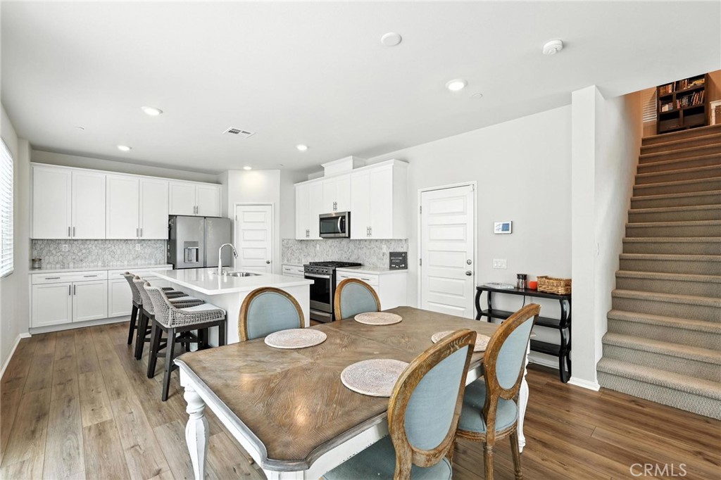 28267 Ashtree Street Temecula, CA 92591 - Photo 13 of 41 a view of a dining room with furniture and wooden floor