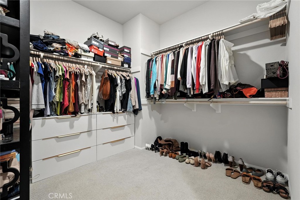 28267 Ashtree Street Temecula, CA 92591 - Photo 30 of 41 a view of walk in closet with clothes and shoes