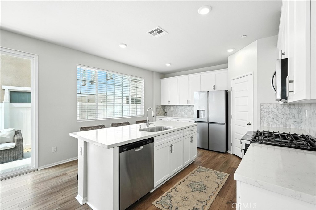 28267 Ashtree Street Temecula, CA 92591 - Photo 8 of 41 a kitchen with a sink stove and refrigerator