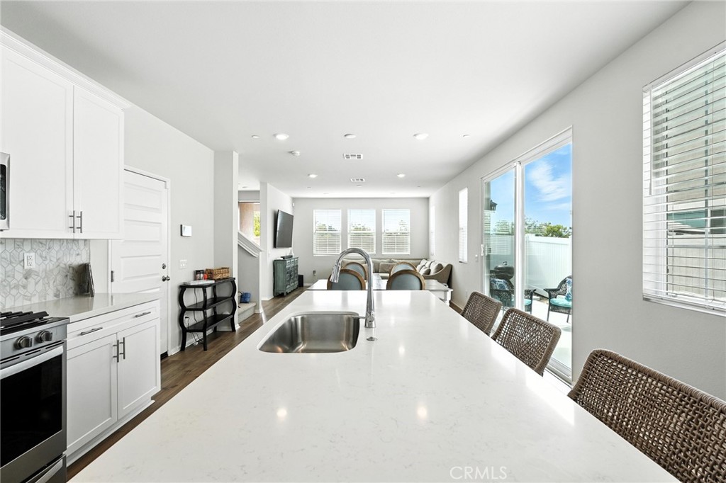 28267 Ashtree Street Temecula, CA 92591 - Photo 10 of 41 a large white kitchen with lots of counter space a sink and appliances