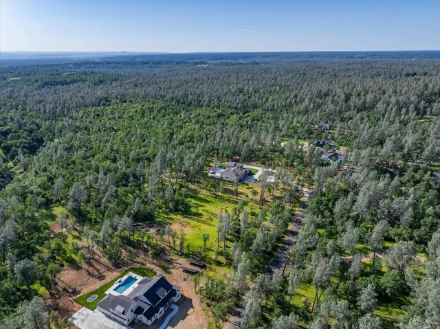 an aerial view of a house with a yard