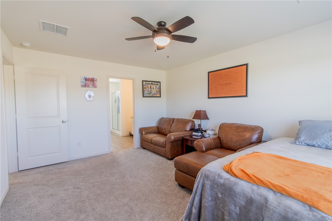 6029 Toby Bend Bryan, TX 77807 - Photo 15 of 25 a bedroom with bed and ceiling fan