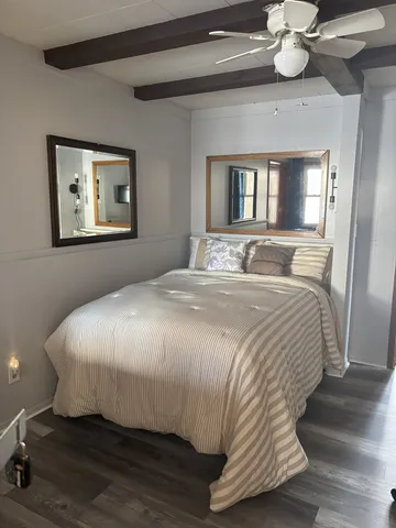 a large bed sitting in a bedroom next to a window