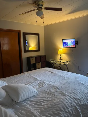 a bedroom with a bed and a flat screen tv