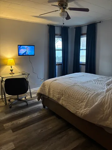 a bedroom with a bed and a flat screen tv