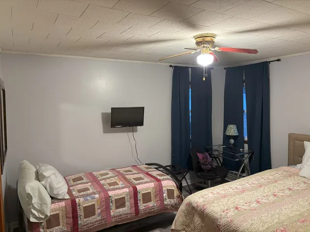 a bedroom with two beds and a chandelier