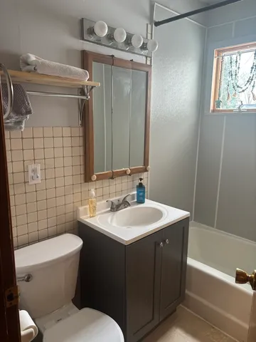 a bathroom with a sink toilet and shower