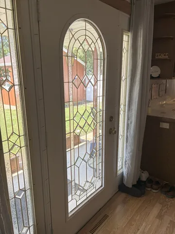 a view of front door with wooden floor
