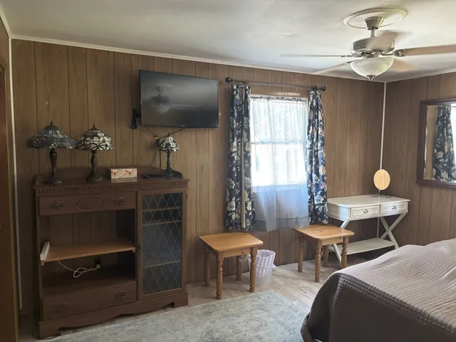 a living room with furniture a chandelier and a window