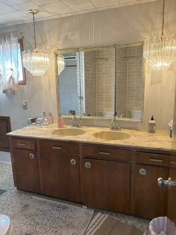 a bathroom with a granite countertop sink mirror and double