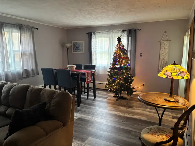 a living room with furniture flowers and a window