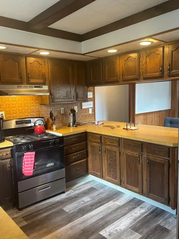 a kitchen with stainless steel appliances granite countertop a stove and a sink