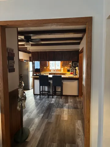 a living room with chairs and a table