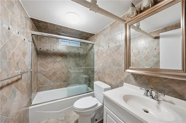 a bathroom with a sink mirror toilet and bathtub