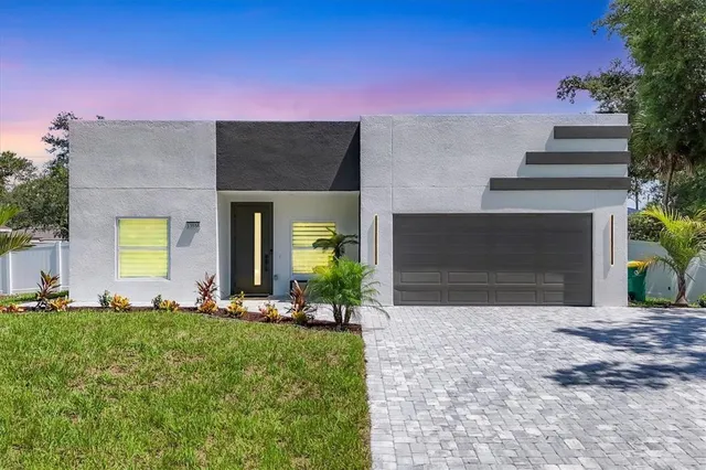 a front view of a house with a yard and garage