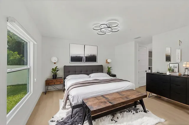 a bedroom with a bed and a table