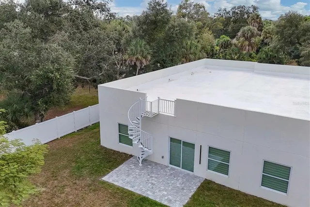 an aerial view of a house with swimming pool garden and patio