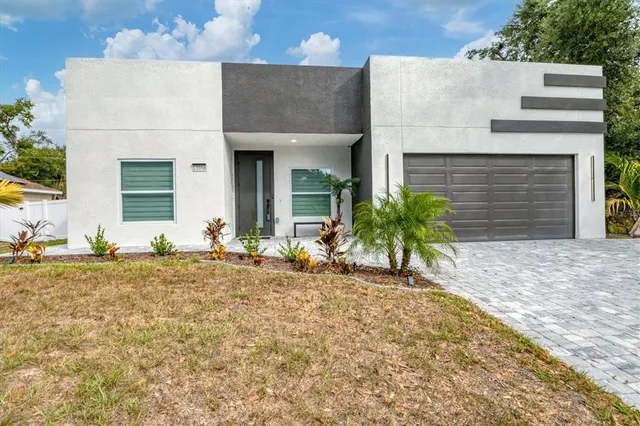 a view of a house with a yard and sitting area