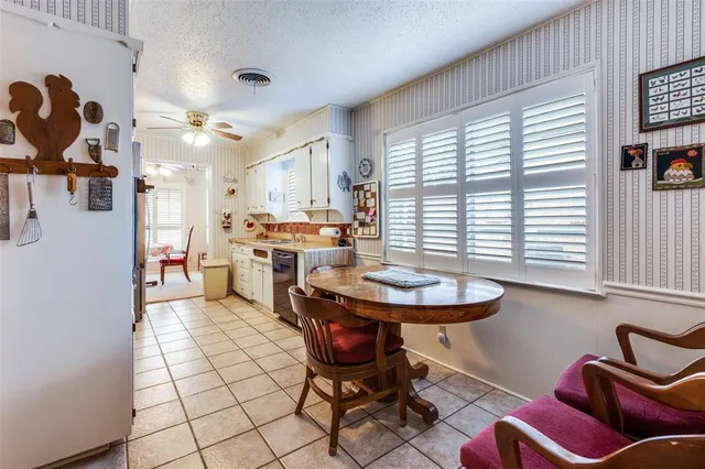 a bedroom with a bed a chandelier and dresser