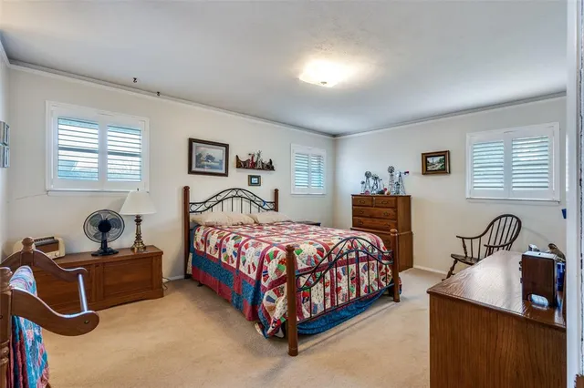 a bedroom with a bed a dresser and a book shelf