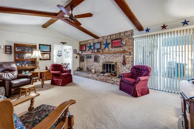 a living room with furniture ceiling fan and a window