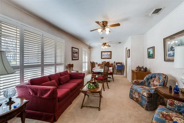 a kitchen with stainless steel appliances kitchen island granite countertop a refrigerator oven a sink dishwasher and white cabinets with wooden floor