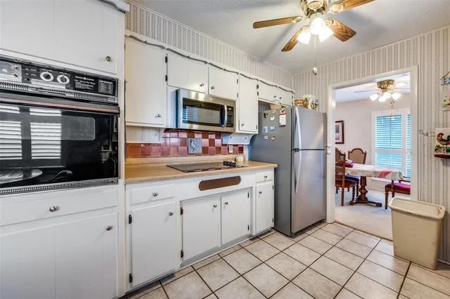 a kitchen with stainless steel appliances granite countertop a refrigerator and a stove