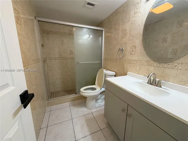 a bathroom with a toilet sink and shower