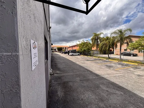 a view of a street with a building in the background