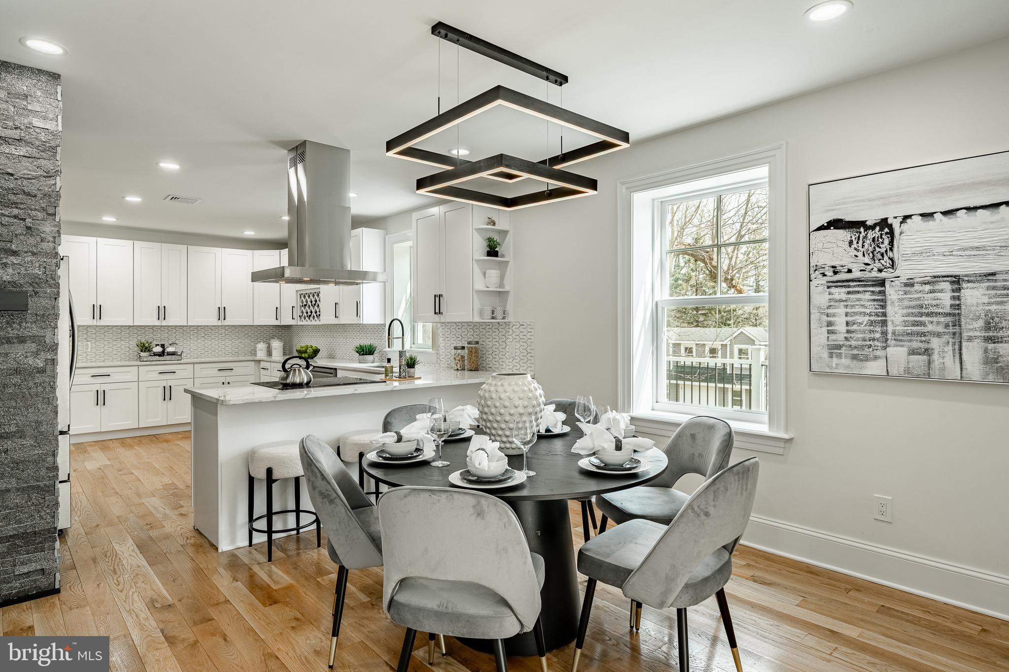370 Boot Road West Chester, PA 19380 - Photo 14 of 56 a kitchen with granite countertop a dining table chairs and white cabinets