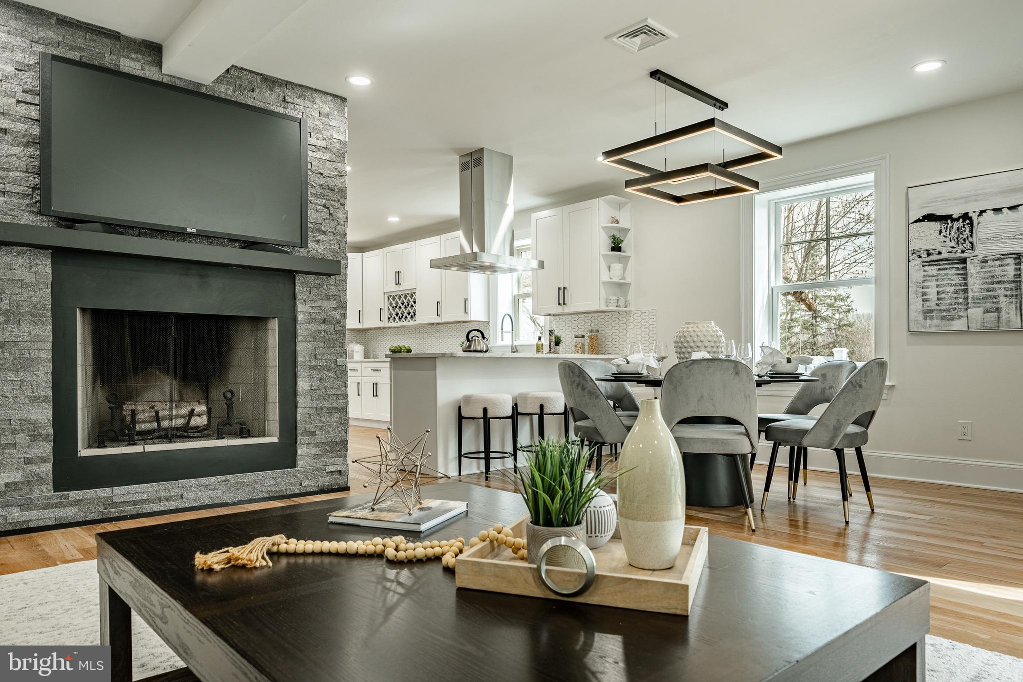 370 Boot Road West Chester, PA 19380 - Photo 8 of 56 a dining room with furniture a fireplace and wooden floor