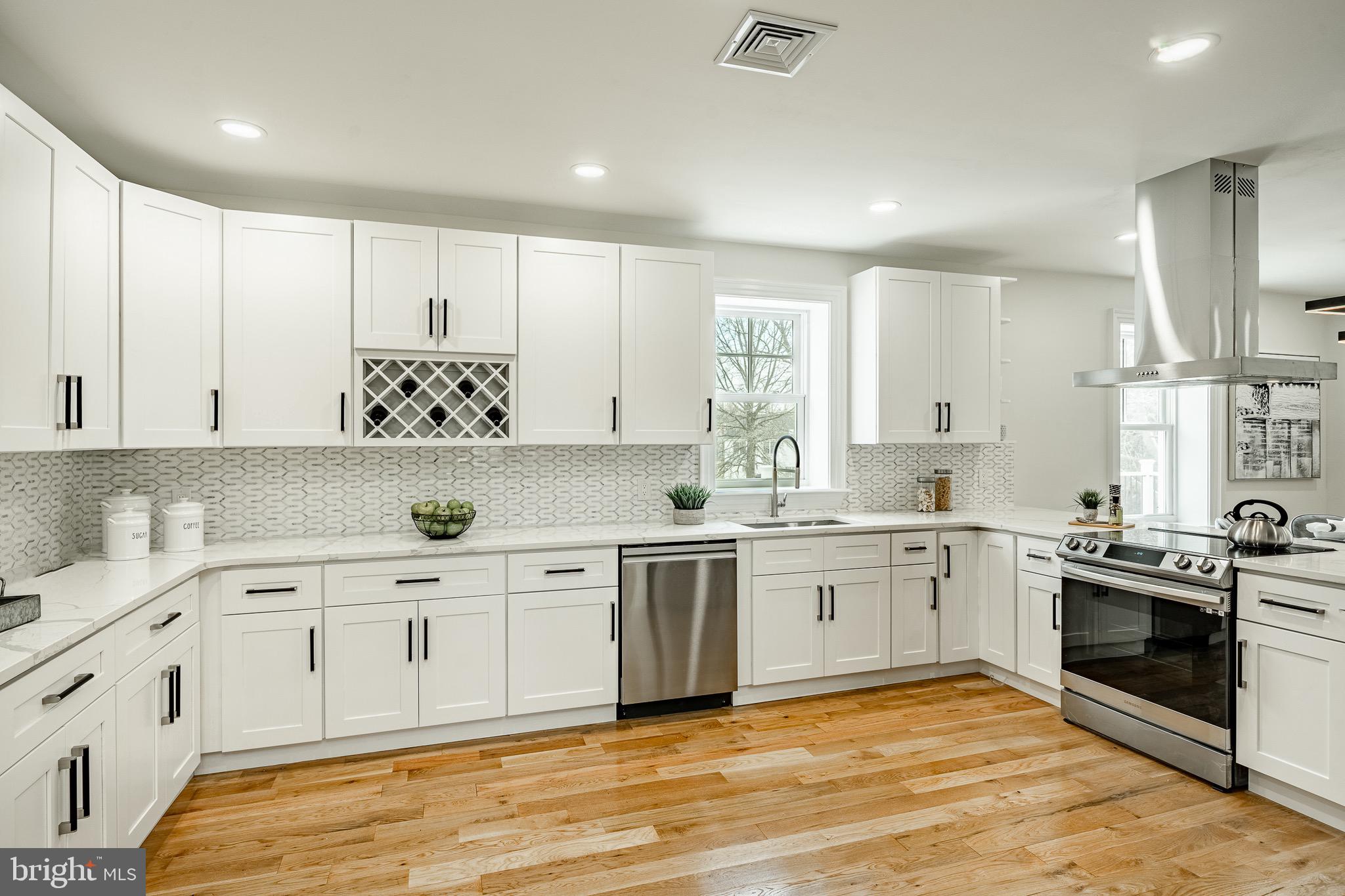 370 Boot Road West Chester, PA 19380 - Photo 9 of 56 a large white kitchen with stainless steel appliances granite countertop a stove and a sink