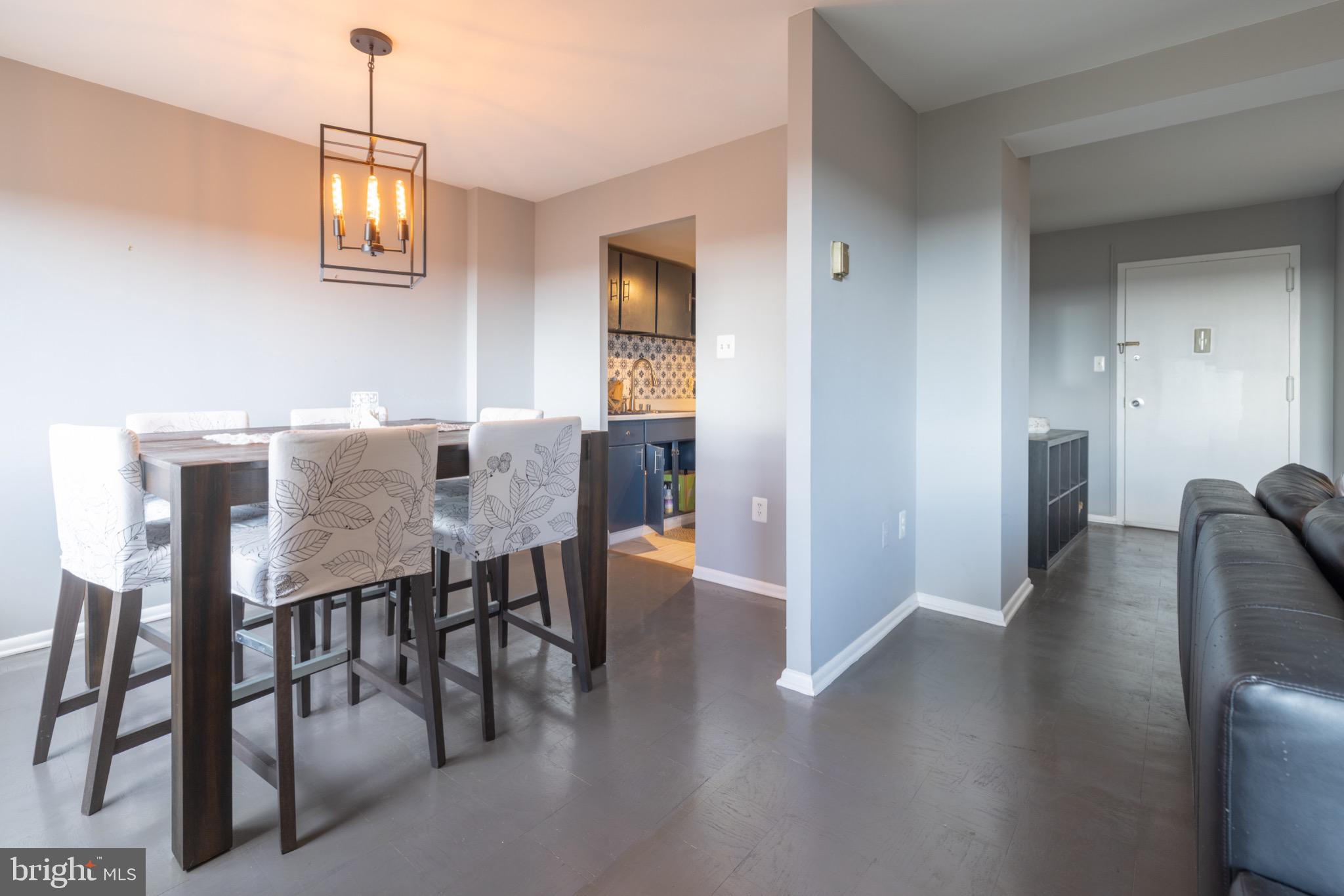 1111 University Boulevard West, Unit 1411A Silver Spring, MD 20902 - Photo 1 of 36 a view of a dining room with furniture and wooden floor