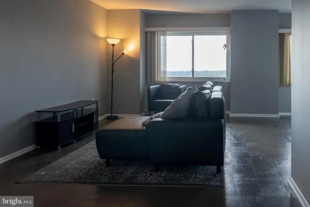 a living room with furniture and a lamp