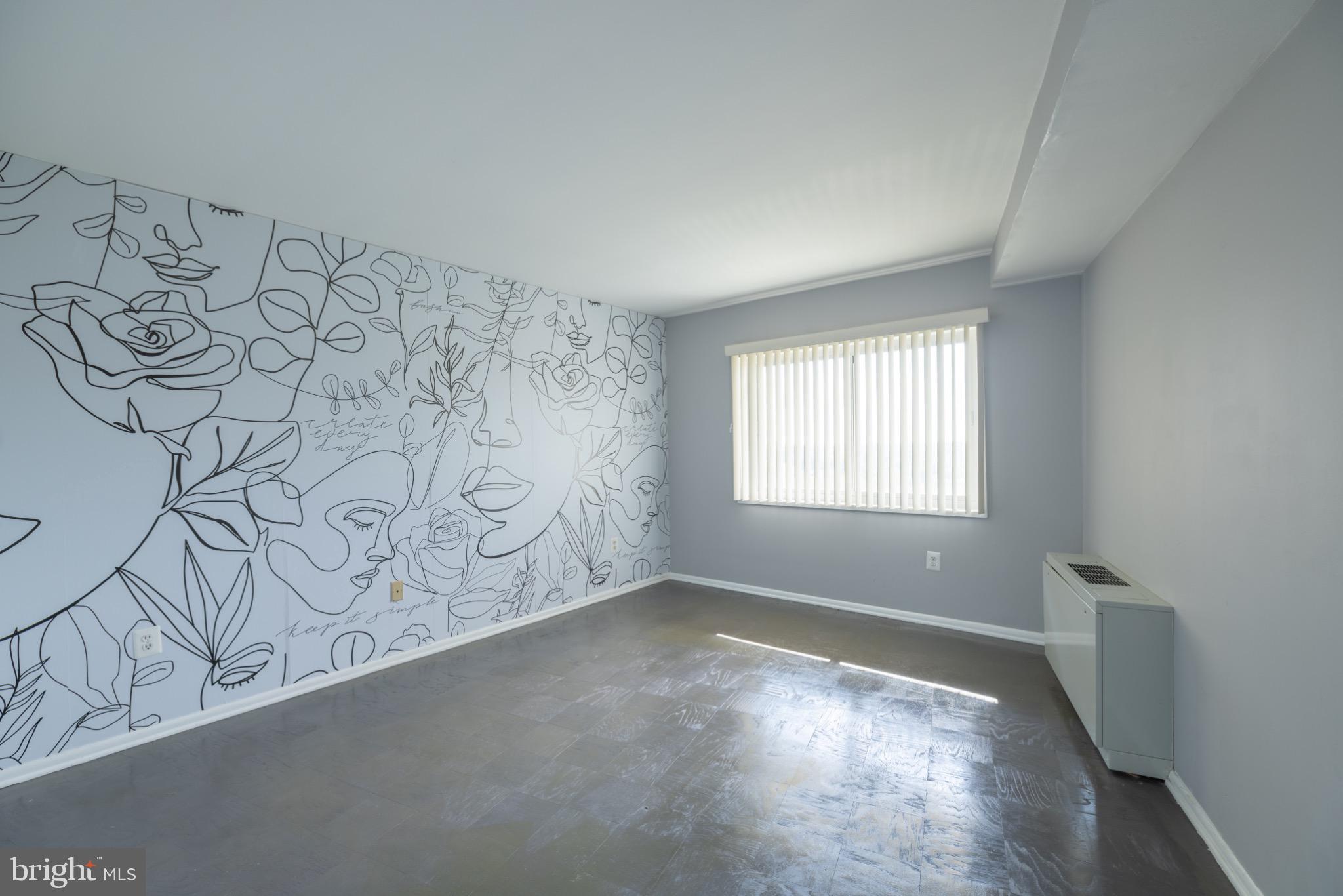 1111 University Boulevard West, Unit 1411A Silver Spring, MD 20902 - Photo 22 of 36 a view of a livingroom with wooden floor and a window