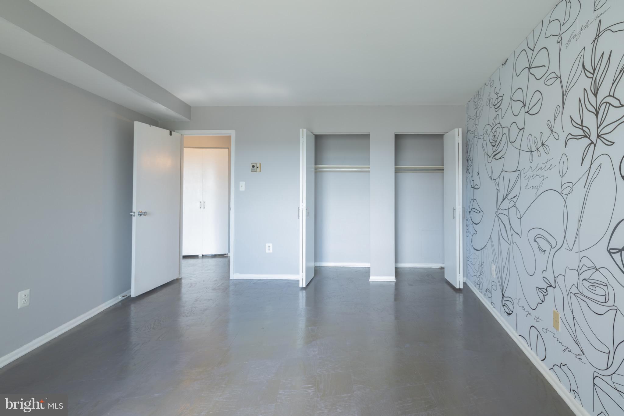 1111 University Boulevard West, Unit 1411A Silver Spring, MD 20902 - Photo 23 of 36 a view of an empty room with wooden floor