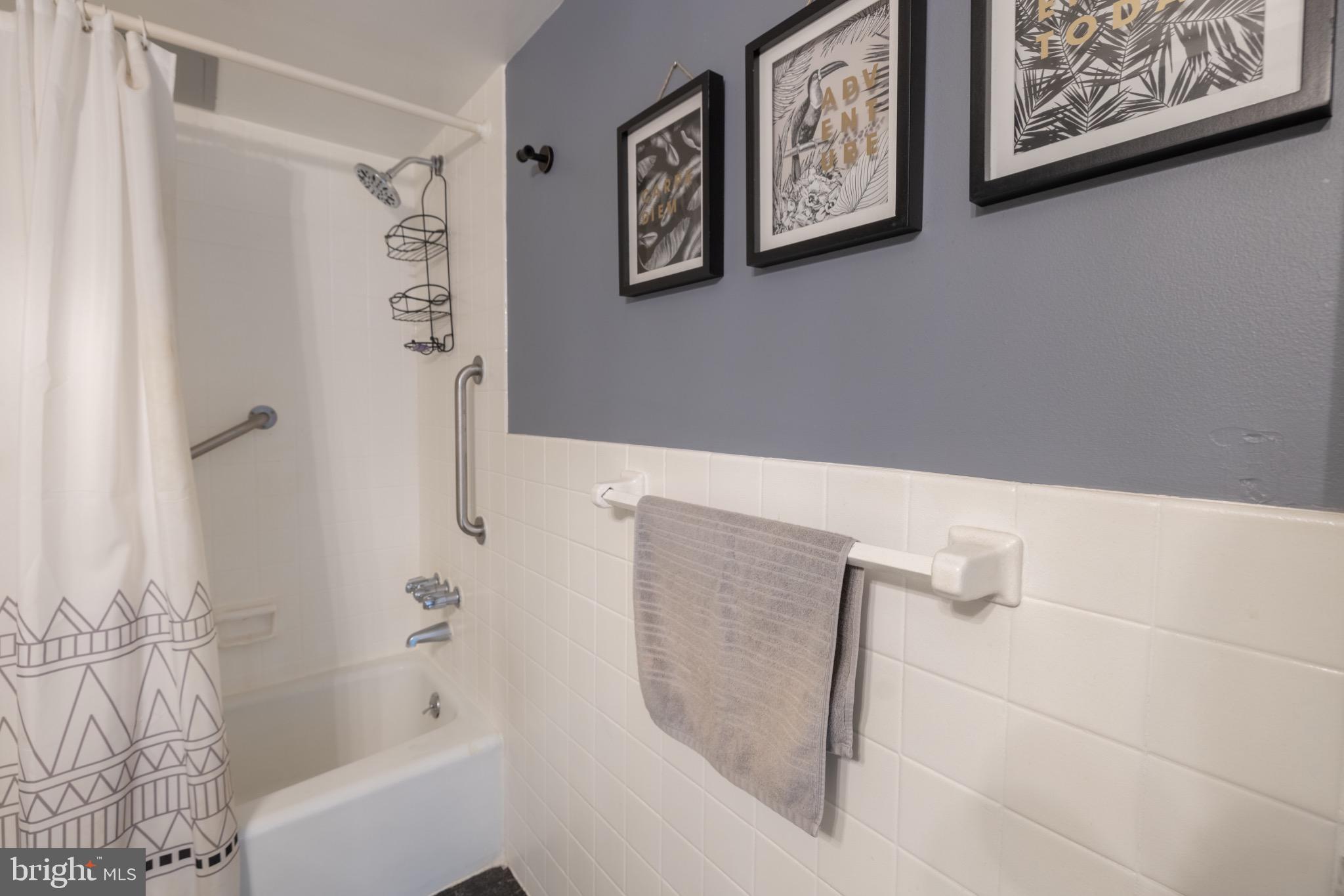 1111 University Boulevard West, Unit 1411A Silver Spring, MD 20902 - Photo 28 of 36 a bathroom with a bathtub and shower