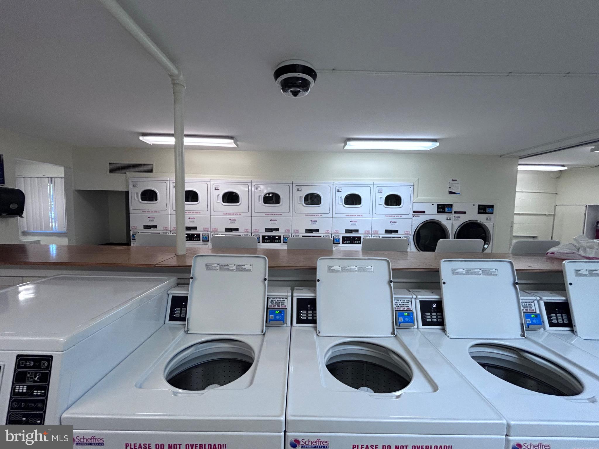 1111 University Boulevard West, Unit 1411A Silver Spring, MD 20902 - Photo 30 of 36 a kitchen with kitchen island stainless steel appliances a sink a stove and a refrigerator