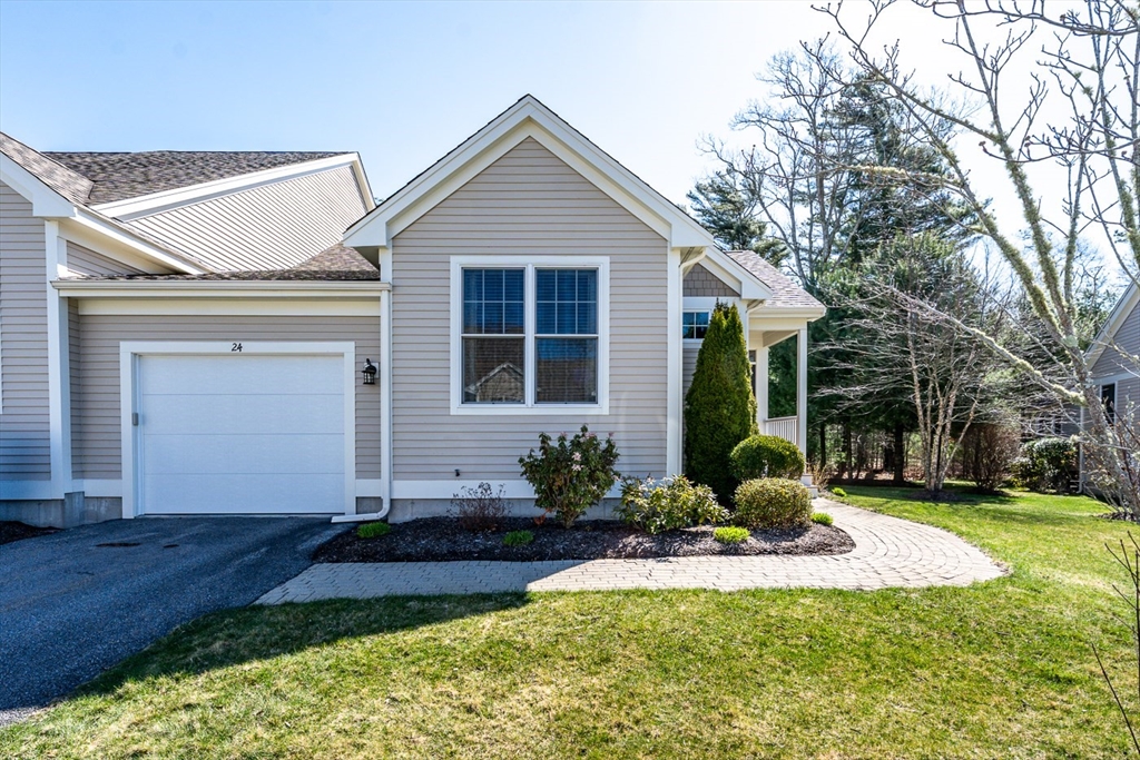 24 Grey Hawk Drive, Unit 646 Mashpee, MA 02649 - Photo 1 of 24 a front view of a house with a yard and porch
