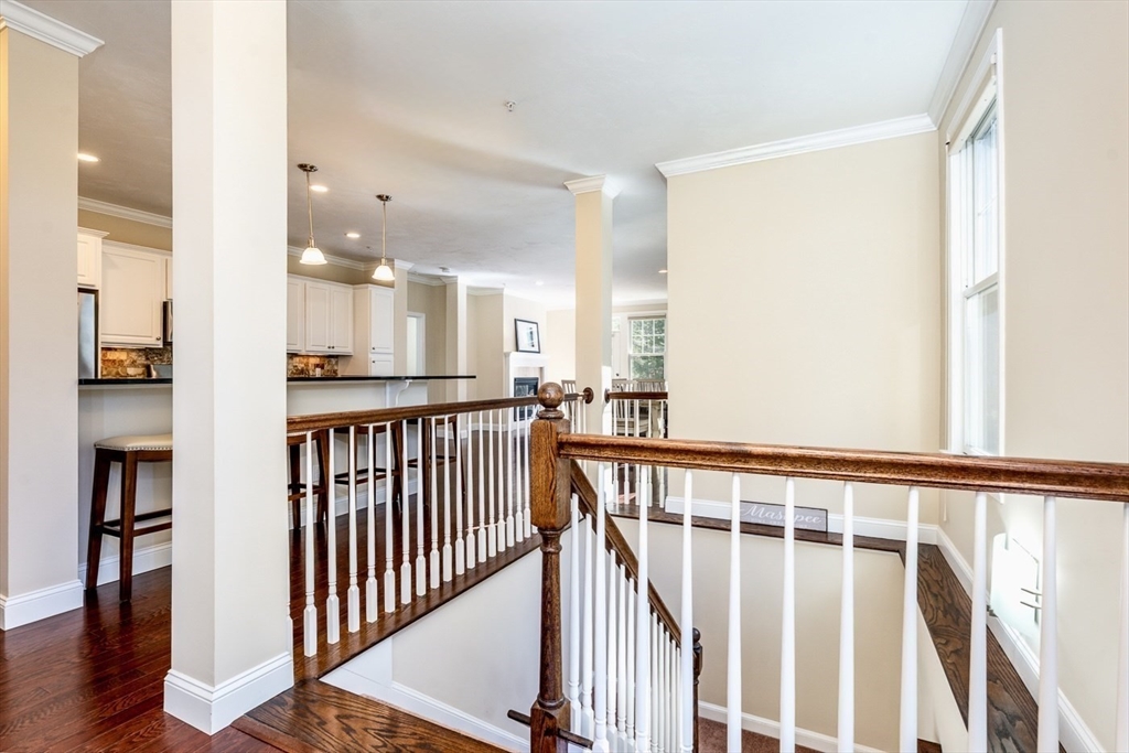 24 Grey Hawk Drive, Unit 646 Mashpee, MA 02649 - Photo 19 of 24 a view of a hallway with wooden floor and staircase