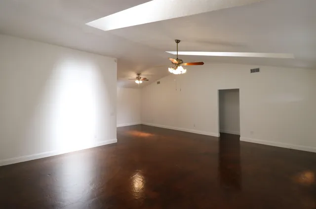 an empty room with wooden floor