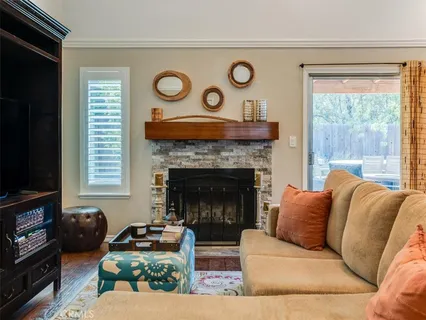 a living room with furniture a flat screen tv and a fireplace