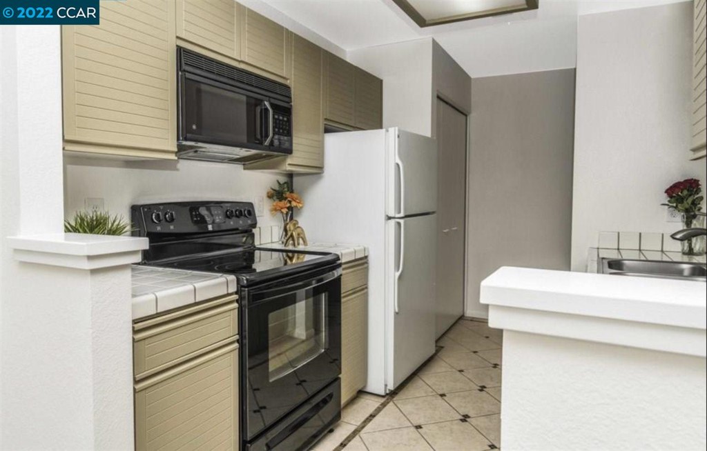 7650 Canyon Meadows Circle Pleasanton, CA 94588 - Photo 12 of 24 a kitchen with a stove and a refrigerator
