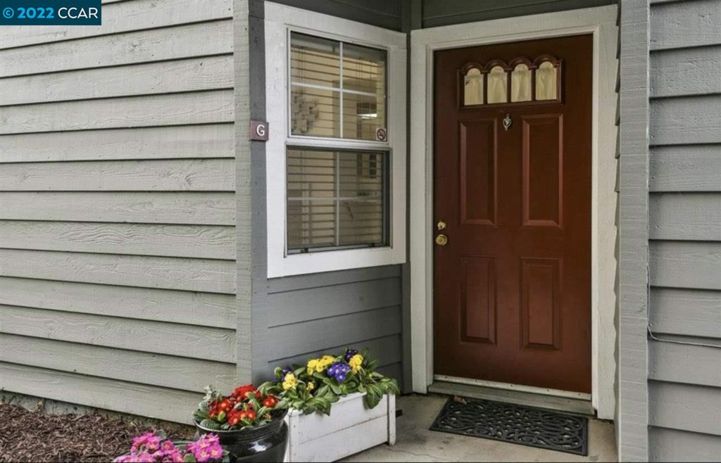 7650 Canyon Meadows Circle Pleasanton, CA 94588 - Photo 4 of 24 a front view of a house with a potted plant and garage
