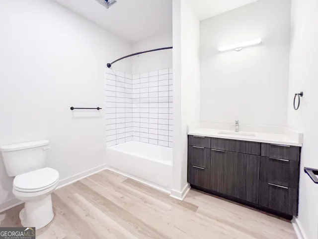 a bathroom with a bathtub shower sink and toilet