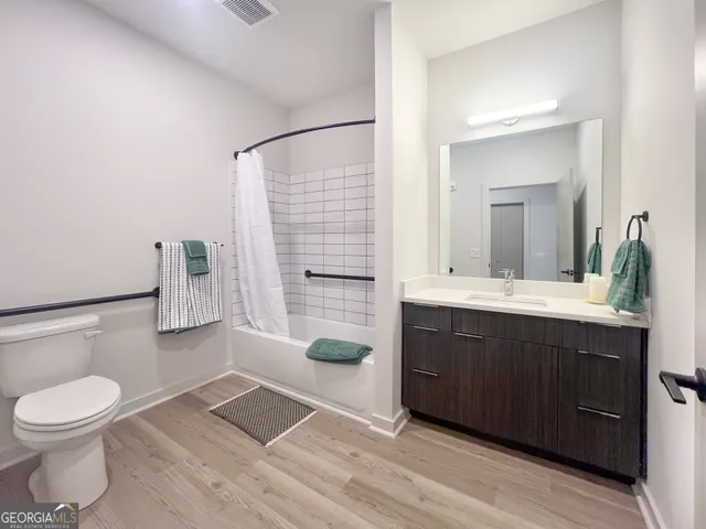 a bathroom with a bathtub sink mirror and toilet