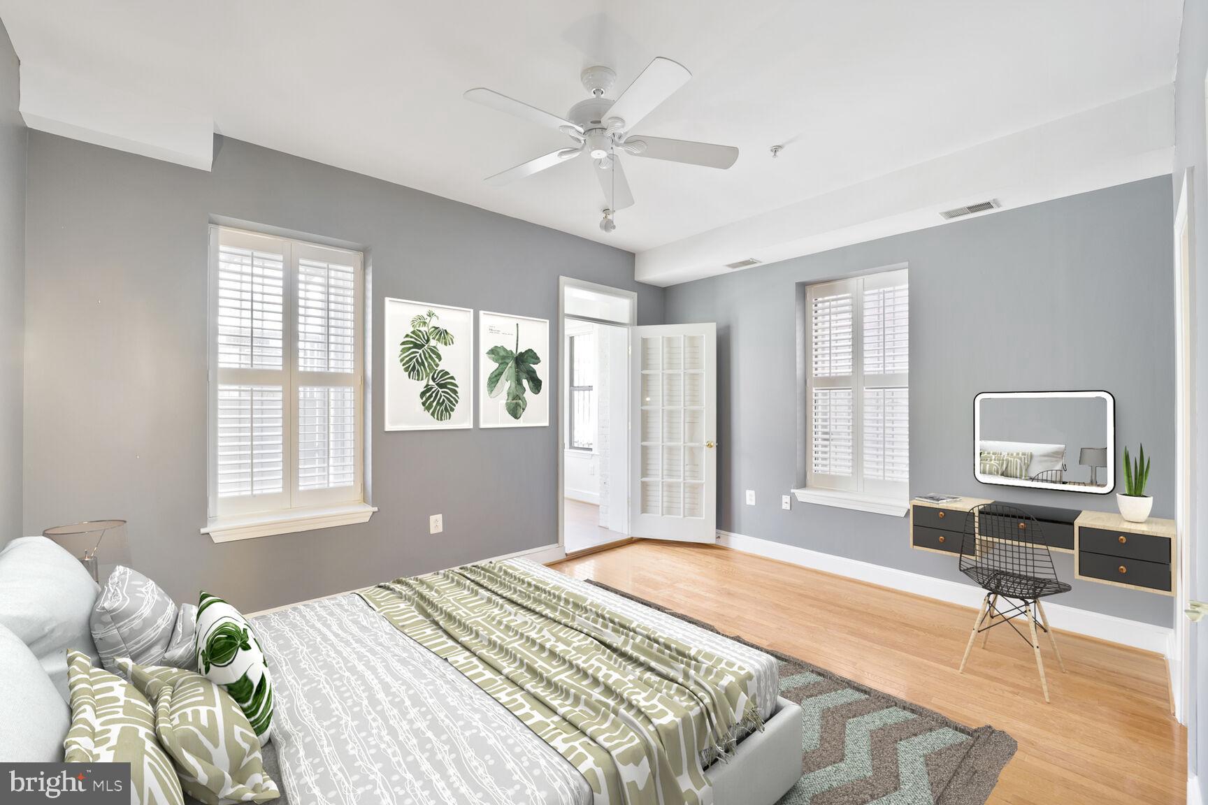 a bedroom with a bed dresser and window